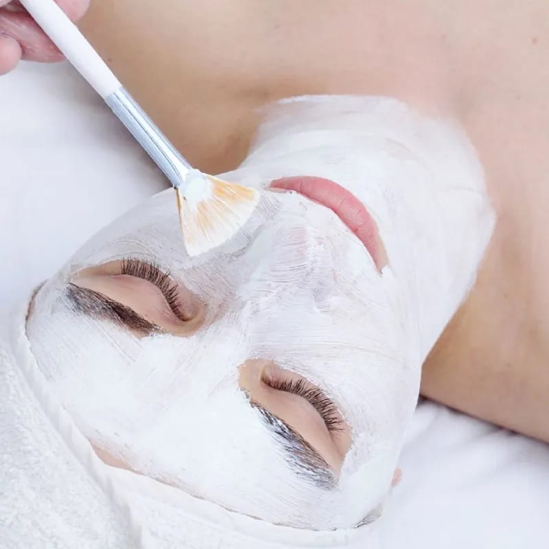 Client receiving a soothing facial mask applied with a brush Client receiving a soothing facial mask applied with a brush