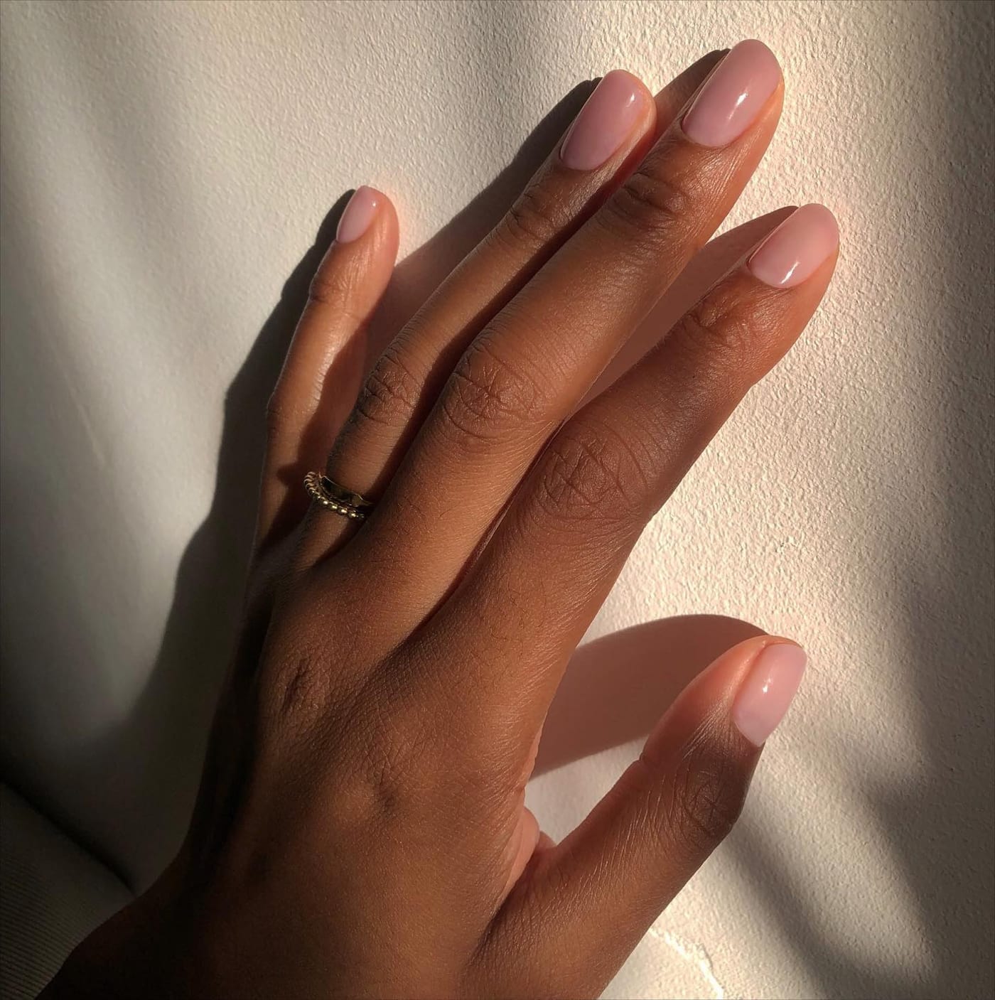 Manicurist carefully tending a client's nails Manicurist carefully tending a client's nails