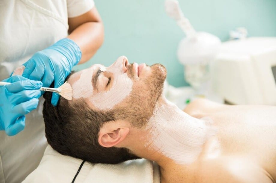 Man receiving a facial clean-up treatment Man receiving a facial clean-up treatment