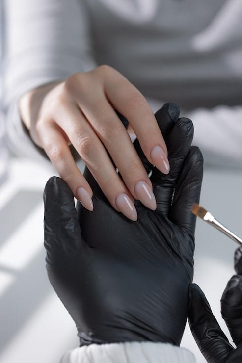 Gel polish being applied to a client's nails Gel polish being applied to a client's nails