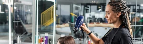 Freshly washed hair being blow-dried by a salon professional