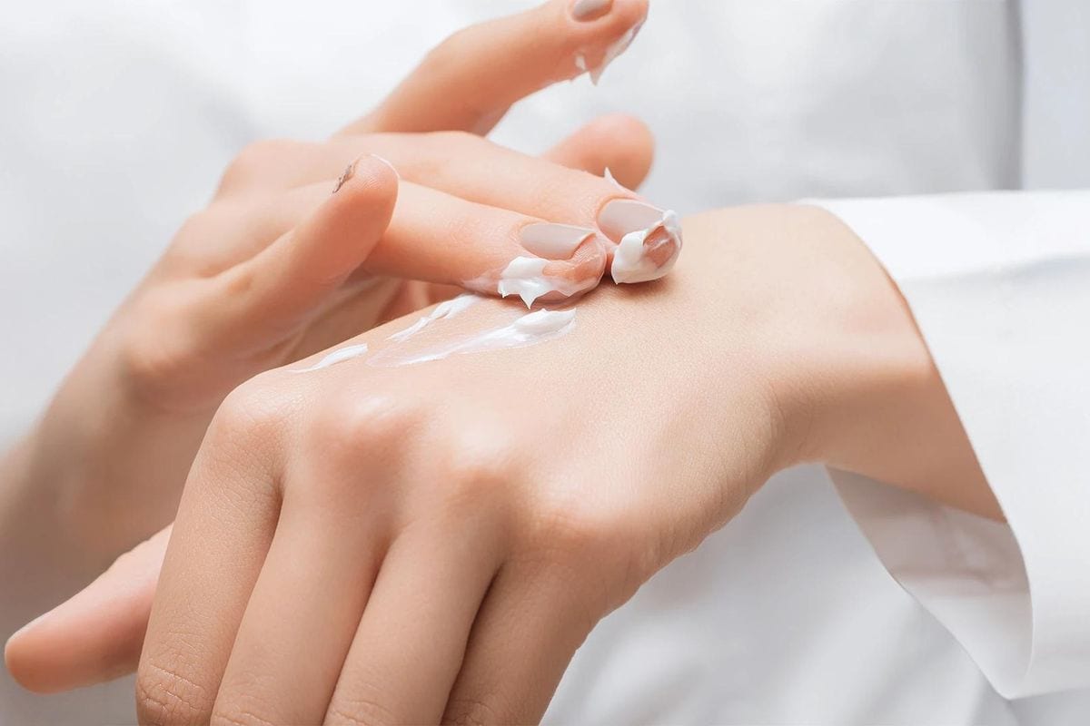 Brightening cream being applied to a client's hand and arm Brightening cream being applied to a client's hand and arm