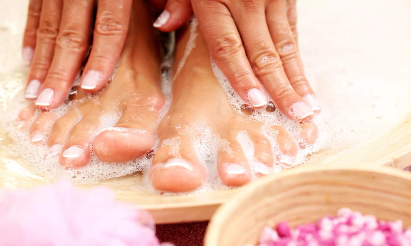 Manicure and pedicure being performed in one combined session Manicure and pedicure being performed in one combined session