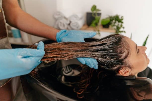 Professional restorative hair treatment applied in a salon