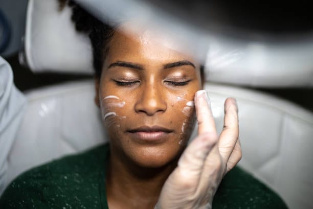 Brightening facial mask applied across a client's face Brightening facial mask applied across a client's face